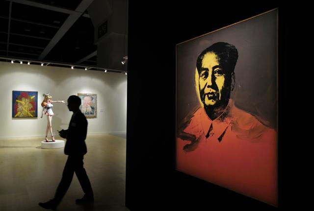 A man walks past the painting at the Sotheby's Modern and Contemporary Art Evening Sale in Hong Kong on March 31, 2017. (AP)