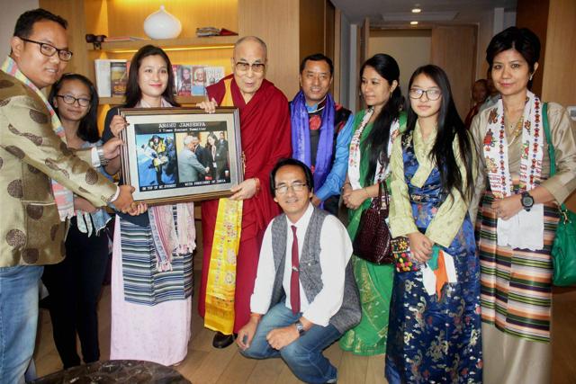The Dalai Lama receives a photo from Anshu Jamsenpa of her successful expeditions to Mt Everest. (PTI)