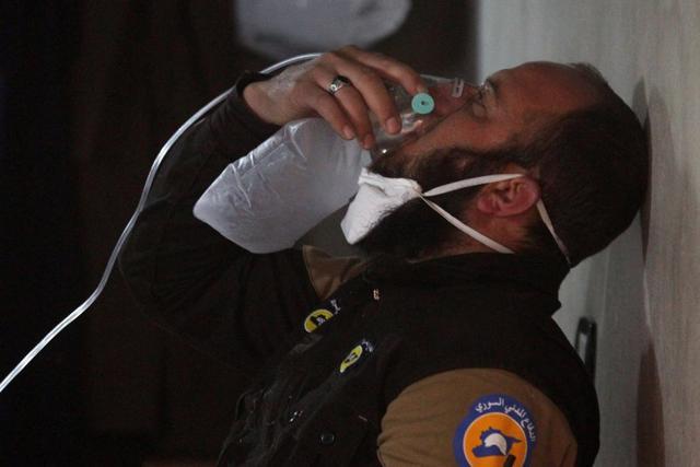 A civil defence member breathes through an oxygen mask, after what rescue workers described as a suspected gas attack in the town of Khan Sheikhoun in rebel-held Idlib. (Reuters Photo) A civil defence member breathes through an oxygen mask, after what rescue workers described as a suspected gas attack in the town of Khan Sheikhoun in rebel-held Idlib. (Reuters Photo)