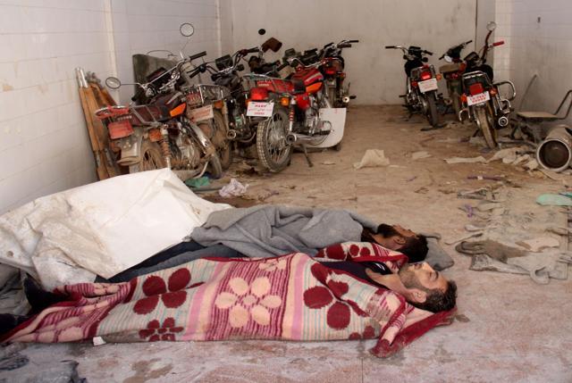 Bodies lie in the parking area of a hospital in Khan Sheikhun. The head of the health authority in rebel-held Idlib province said more than 50 people had been killed. (AFP Photo) Bodies lie in the parking area of a hospital in Khan Sheikhun. The head of the health authority in rebel-held Idlib province said more than 50 people had been killed. (AFP Photo)