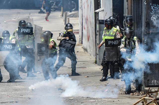 Venezuelan police clash with opposition activists during a protest against the government of President Nicolas Maduro in Caracas. (AFP) Venezuelan police clash with opposition activists during a protest against the government of President Nicolas Maduro in Caracas. (AFP)