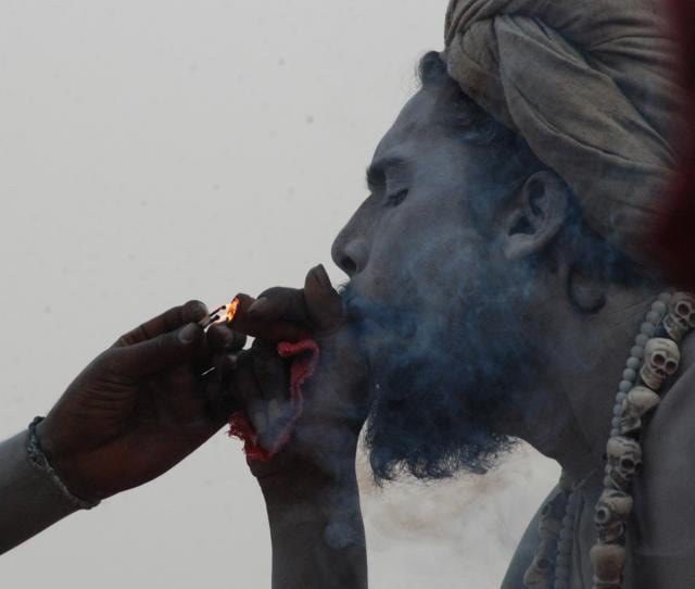 A sadhu smokes a chillum made up of traditional clay pipe as a holy offering to Lord Shiva at Varanasi. There are six main schools of Hinduism, but people often identify with sects – such as Vaishnavites or Shaivities or worshippers of Shakti. (Rajesh Kumar / HT Photo)
