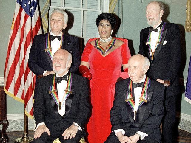 This 1994 file photo shows actor Kirk Douglas (standing-from-left), singer Aretha Franklin, singer Peter Seeger and (seated from left) director Harold Prince and composer Morton Gould pose for photographers after a dinner at the State Department in Washington. The dinner was to honour them as recipients of the Kennedy Center Honours of 1994. This 1994 file photo shows actor Kirk Douglas (standing-from-left), singer Aretha Franklin, singer Peter Seeger and (seated from left) director Harold Prince and composer Morton Gould pose for photographers after a dinner at the State Department in Washington. The dinner was to honour them as recipients of the Kennedy Center Honours of 1994.