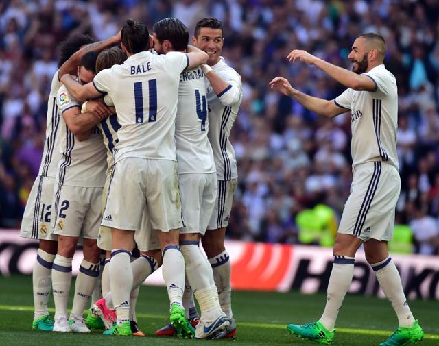Real Madrid players celebrate their opening goal during the La Liga match against Atletico Madrid. (AFP) Real Madrid players celebrate their opening goal during the La Liga match against Atletico Madrid. (AFP)