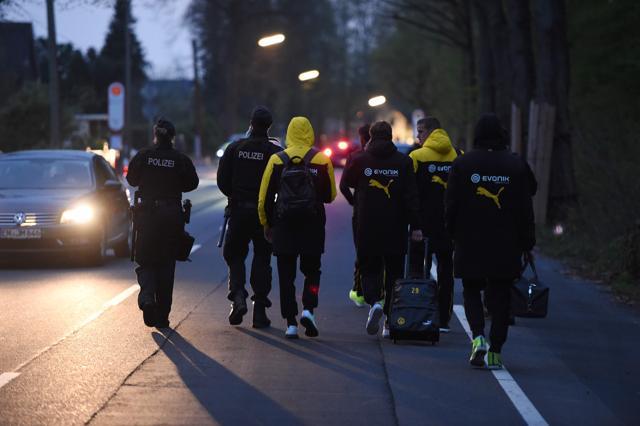 Police escort Borussia Dortmund's players after the blast near the team bus some 10km away from the stadium prior to the UEFA Champions League match against AS Monaco in Dortmund. (AFP) Police escort Borussia Dortmund's players after the blast near the team bus some 10km away from the stadium prior to the UEFA Champions League match against AS Monaco in Dortmund. (AFP)