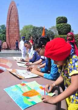 Students taking part in an art competition at the Jallianwala Bagh in Amritsar on Thursday. (HT Photo)