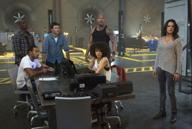 This image released by Universal Pictures shows, Chris ‘Ludacris’ Bridges, seated left, and Nathalie Emmanuel, seated right, and Tyrese Gibson, standing from left, Scott Eastwood, Dwayne Johnson and Michelle Rodriguez in The Fate of the Furious. (AP)