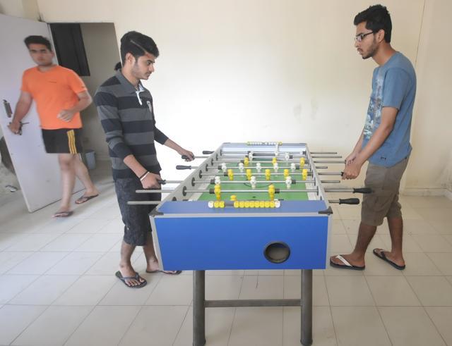 Boys play foosball at the Aarusha Homes hostel in Pune. (HT PHOTO )