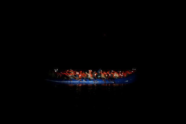 Migrants on a rubber dinghy await rescue by the Malta-based NGO Migrant Offshore Aid Station (MOAS) in the central Mediterranean in international waters off the coast of Sabratha in Libya, April 15. (REUTERS)