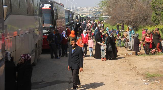 Syrians who arrived a day earlier from government-held vilages of Fuaa and Kafraya wait in rebel-held Rashidin, west of Aleppo city, following delays in evacuating them as the hard-won deal ran into trouble on April 15, 2017. (AFP Photo) Syrians who arrived a day earlier from government-held vilages of Fuaa and Kafraya wait in rebel-held Rashidin, west of Aleppo city, following delays in evacuating them as the hard-won deal ran into trouble on April 15, 2017. (AFP Photo)