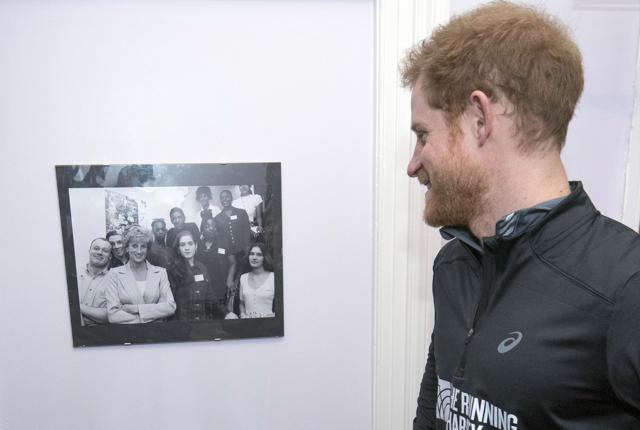 Britain's Prince Harry looks at a photo of his mother Princess Diana. (AP Photo) Britain's Prince Harry looks at a photo of his mother Princess Diana. (AP Photo)
