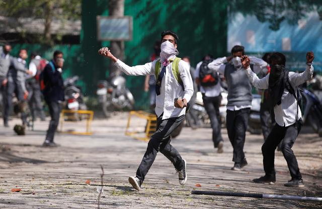 A Kashmiri student throws a stone during a protest in Srinagar last week. (REUTERS) A Kashmiri student throws a stone during a protest in Srinagar last week. (REUTERS)