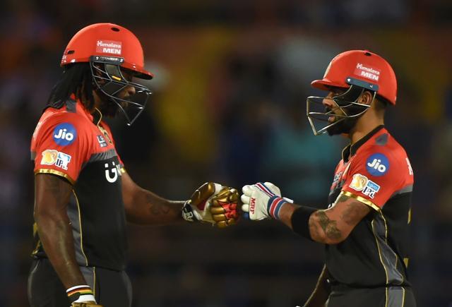 Virat Kohli (R) pumps fists with teammate Chris Gayle during the 2017 Indian Premier League match between Gujarat Lions and Royal Challengers Bangalore at the Saurashtra Cricket Association Stadium in Rajkot on Tuesday. (AFP) Virat Kohli (R) pumps fists with teammate Chris Gayle during the 2017 Indian Premier League match between Gujarat Lions and Royal Challengers Bangalore at the Saurashtra Cricket Association Stadium in Rajkot on Tuesday. (AFP)
