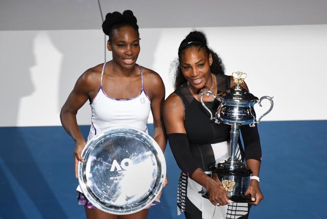 Serena Williams of the US (R) holds the winner's trophy as she poses with sister Venus Williams at the awards ceremony following the women's singles final of the Australian Open tennis tournament in Melbourne. (AFP) Serena Williams of the US (R) holds the winner's trophy as she poses with sister Venus Williams at the awards ceremony following the women's singles final of the Australian Open tennis tournament in Melbourne. (AFP)