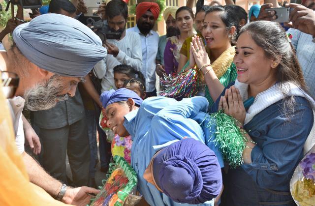 Harjit Sajjan interacting with conjoined twins — Sona and Mona — during his visit to Pingalwara in Amritsar on Thursday. (Gurpreet Singh/HT)