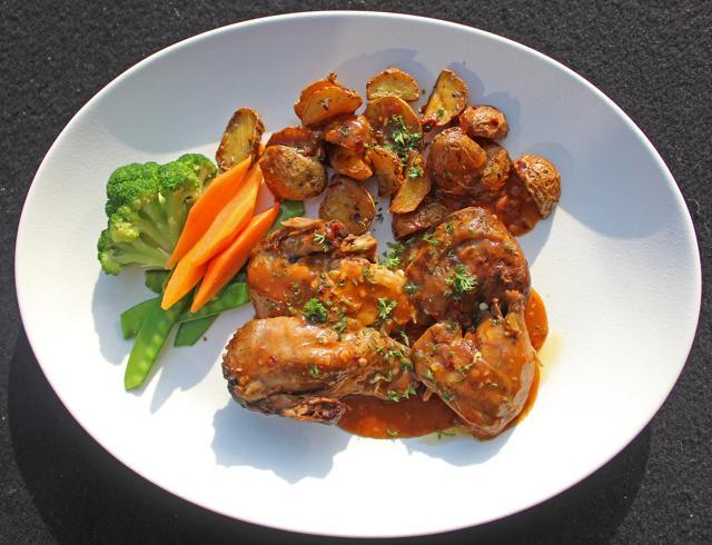 The galletto at The Stables features hunks of peri peri-spiced grilled chicken (so soft they fall off the bone) with baby potatoes. It’s classic comfort fare. (Satyabrata Tripathy/HT Photo)