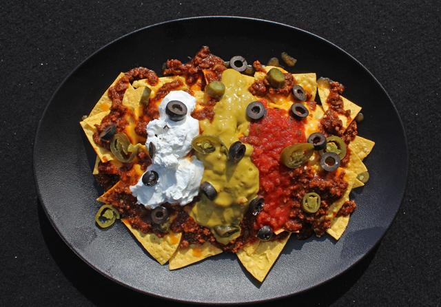 The classic nachos at The Stables are a great opening act. Tender bits of spicy pork, guacamole and pico de gallo sit atop cheesy chipotle-dusted tortilla chips. (Satyabrata Tripathy / HT Photo)