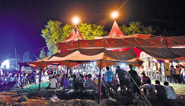 Guests at a wedding watching a live performance in an illuminated canopy on the outskirts of Ara, Bihar. (Ravi Choudhary/HT PHOTO)