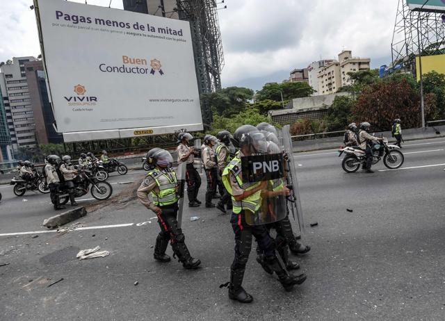 Riot police officers in position to crack down on demonstrators during a protest against Venezuelan President Nicolas Maduro, in Caracas on April 20. (AFP Photo) Riot police officers in position to crack down on demonstrators during a protest against Venezuelan President Nicolas Maduro, in Caracas on April 20. (AFP Photo)