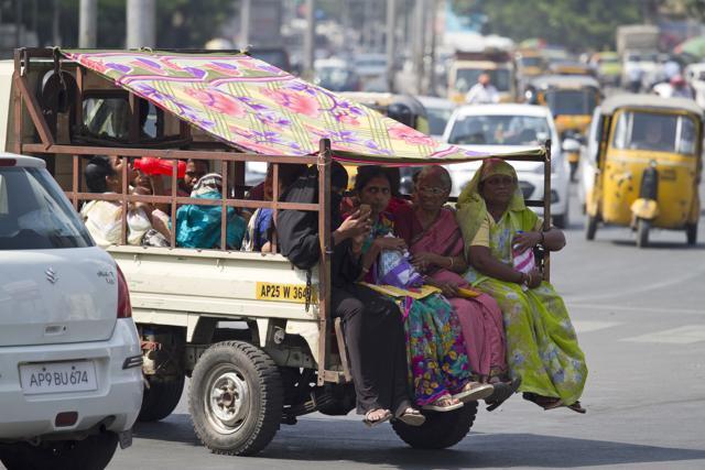 People travel in the back of a van with a sheet spread on top to protect them from the heat on a hot summer afternoon in Hyderabad. (AP Photo) People travel in the back of a van with a sheet spread on top to protect them from the heat on a hot summer afternoon in Hyderabad. (AP Photo)