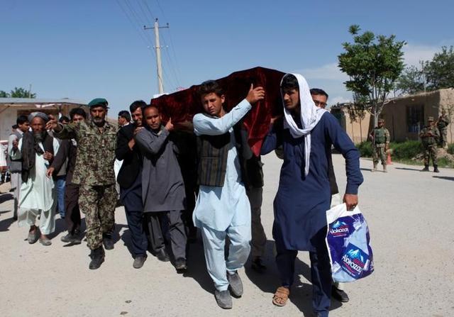 Relatives carry the coffin of one of the victims a day after the attack. (Reuters)