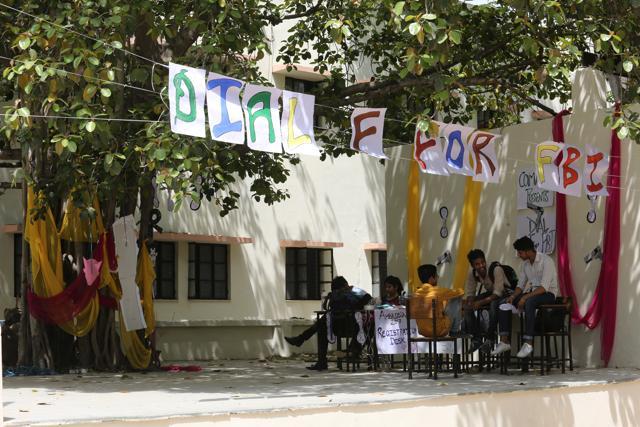 Students sit around an empty registration desk waiting for the performances to begin. (AMAL KS/ HT Photo)