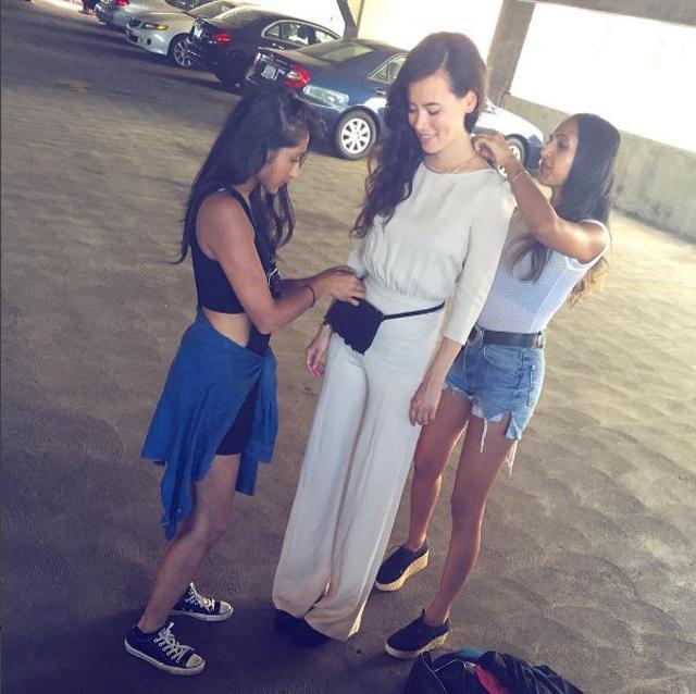 The sisters styling a model for a look book shoot. (Instagram)