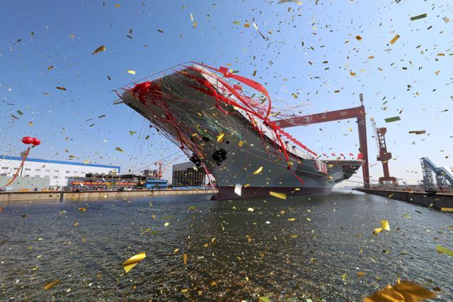 The newly-built aircraft carrier is transferred from dry dock into the water at a launch ceremony at a shipyard in Dalian. (AP Photo) The newly-built aircraft carrier is transferred from dry dock into the water at a launch ceremony at a shipyard in Dalian. (AP Photo)