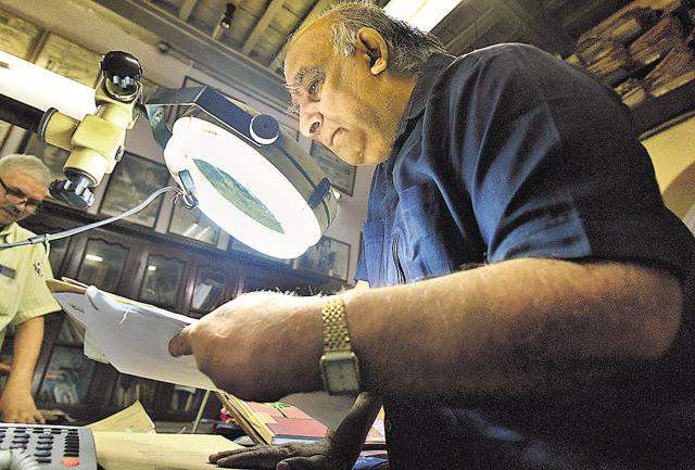 Ashok Kashyap, an expert examiner of forensic finger prints, handwriting, forgery and questioned documents, at his office at Kashmere Gate. (Vipin Kumar/HT PHOTO)