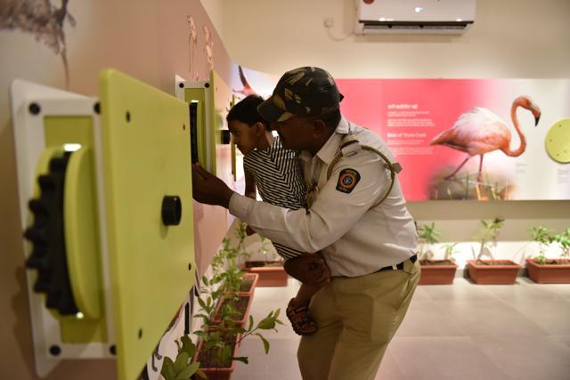 A security officer checks one of the exhibits. (Bachchan Kumar)