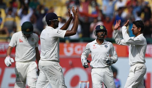 India's Kuldeep Yadav (R) celebrates the caught and bowled dismissal of Australia's Pat Cummins (L) with teammate Ravichandran Ashwin (2L) as wicketkeeper Wriddhiman Saha (2R) looks on during the fourth and last Test in Dharamsala on March 25, 2017. (AFP) India's Kuldeep Yadav (R) celebrates the caught and bowled dismissal of Australia's Pat Cummins (L) with teammate Ravichandran Ashwin (2L) as wicketkeeper Wriddhiman Saha (2R) looks on during the fourth and last Test in Dharamsala on March 25, 2017. (AFP)