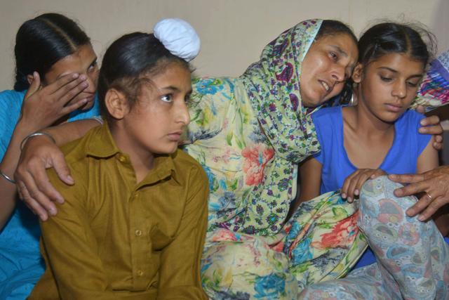 Paramjeet Kaur cries with her children at their residence. (AFP Photo) Paramjeet Kaur cries with her children at their residence. (AFP Photo)