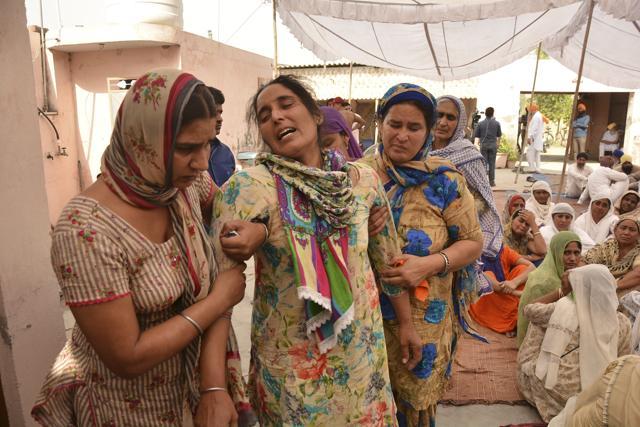 Relatives and friends try to comfort Paramjit Kaur. (AP) Relatives and friends try to comfort Paramjit Kaur. (AP)