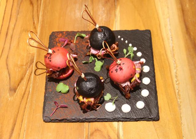 The pork sliders are just bitty domes of bread in deep pink and black, encasing sugary pulled pork dulled by coleslaw. (Bhushan Koyande / HT Photo)