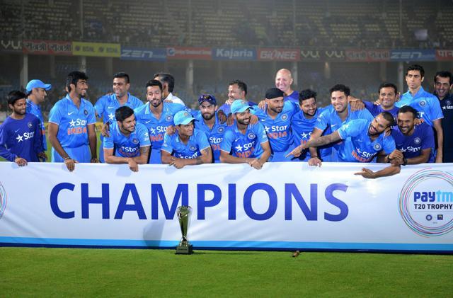 This file photo taken on February 14, 2016 shows India's 2016 cricket team posing with the Champions Trophy during the third T20 international match between India and Sri Lanka in Visakhapatnam. India have kept the announcement of their ICC Champions Trophy squad on hold after BCCI was out-voted on the new governance and revenue structure at the ICC board meeting in Dubai. The BCCI has already missed the April 25, 2017 deadline in naming the squad for the eight-nation event starting June 1 in England and Wales. (AFP)