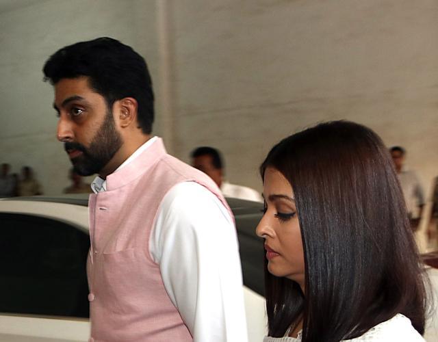 Actor Abhishek Bachchan (L) walks with actor wife Aishwarya Rai Bachchan. (AFP)