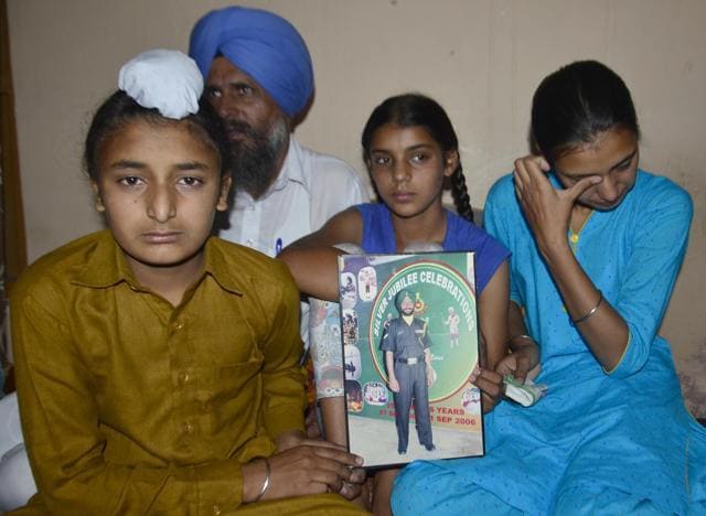 (From left) Naib subedar Paramjit Singh’s son Sahildeep Singh with twin sister Khushdeep Kaur and elder sister Simardeep Kaur as their uncle Ranjit Singh looks on in Vain Poin village of Tarn Taran district. (Sameer Sehgal/HT Photo) (From left) Naib subedar Paramjit Singh’s son Sahildeep Singh with twin sister Khushdeep Kaur and elder sister Simardeep Kaur as their uncle Ranjit Singh looks on in Vain Poin village of Tarn Taran district. (Sameer Sehgal/HT Photo)