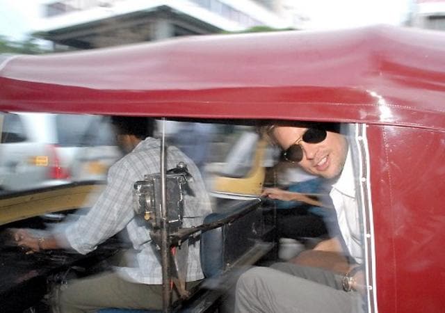 Brad Pitt leans out of an Indian auto rickshaw as he and Angelina Jolie take a tour of Pune. (AFP) Brad Pitt leans out of an Indian auto rickshaw as he and Angelina Jolie take a tour of Pune. (AFP)