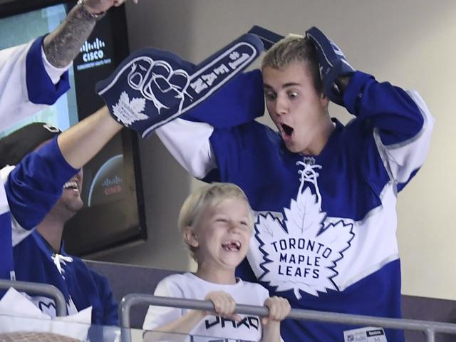 Singer Justin Bieber jokes with a friend during a break in the play during the second period of Game 6 of an NHL hockey Stanley Cup first-round playoff series between the Washington Capitals and the Toronto Maple Leafs in Toronto on Sunday, April 23. (AP)