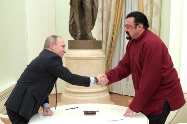 Russian President Vladimir Putin (L) shakes hands with US action star Steven Seagal after presenting a Russian passport to him during a meeting at the Kremlin in Moscow on November 25, 2016. (AFP) Russian President Vladimir Putin (L) shakes hands with US action star Steven Seagal after presenting a Russian passport to him during a meeting at the Kremlin in Moscow on November 25, 2016. (AFP)