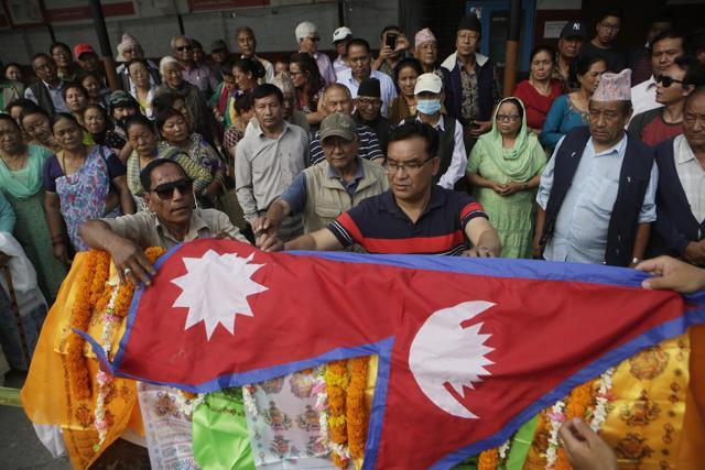 Family members of Nepalese climber Min Bahadur Sherchan honour him with the Nepalese flag on his body during his funeral in Kathmandu on Sunday. (AP Photo) Family members of Nepalese climber Min Bahadur Sherchan honour him with the Nepalese flag on his body during his funeral in Kathmandu on Sunday. (AP Photo)