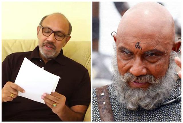 Sathyaraj who plays Kattappa wears a circular silver neckband, earrings and a bindi-tattoo on his forehead. He is seen in a silver mesh attire with a brown side sling. The actor loves wearing casual polo tees and dons spectacles in real life. Sathyaraj who plays Kattappa wears a circular silver neckband, earrings and a bindi-tattoo on his forehead. He is seen in a silver mesh attire with a brown side sling. The actor loves wearing casual polo tees and dons spectacles in real life.