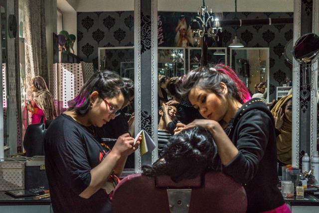 Afghan beauticians Sadaf (left), 17, and Rubina, 20, tend to a client at a beauty parlour in Kabul. (AFP) Afghan beauticians Sadaf (left), 17, and Rubina, 20, tend to a client at a beauty parlour in Kabul. (AFP)