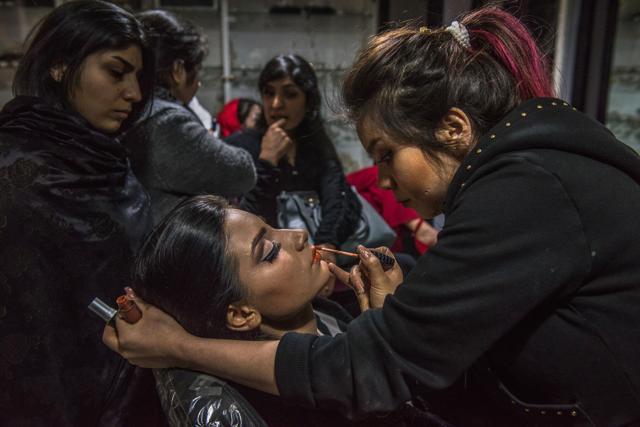 In this photograph taken on March 23, 2017, Afghan beautician Rubina (R), 20, and who has worked at the beauty parlour for six months, applies make-up for a client at a beauty parlour in Kabul. After the Taliban regime was toppled in 2001, small oases began to flourish in the Afghan capital -- glittering feminine spaces in stark contrast to the dusty, dangerous, male-dominated streets outside. (AFP) In this photograph taken on March 23, 2017, Afghan beautician Rubina (R), 20, and who has worked at the beauty parlour for six months, applies make-up for a client at a beauty parlour in Kabul. After the Taliban regime was toppled in 2001, small oases began to flourish in the Afghan capital -- glittering feminine spaces in stark contrast to the dusty, dangerous, male-dominated streets outside. (AFP)