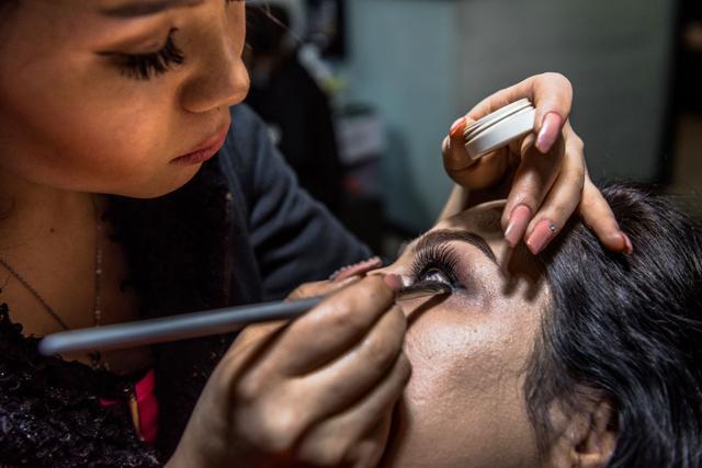 An Afghan beautician applies eye make-up for a client at a beauty parlour in Kabul. (AFP) An Afghan beautician applies eye make-up for a client at a beauty parlour in Kabul. (AFP)