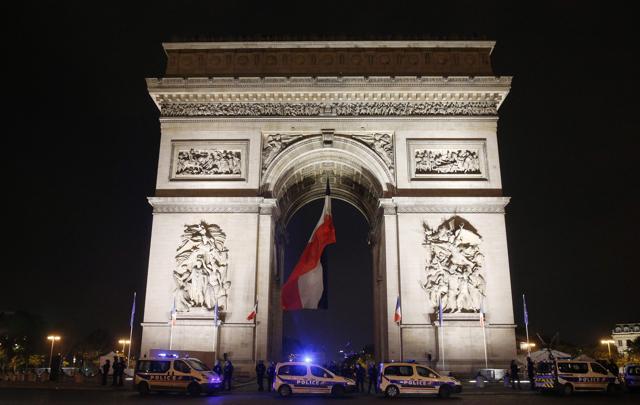 French police officers stand guard by their vehicles next to the Arc de Triomphe of the Place de l'Etoile by the French avenue of the Champs Elysees on May 7, 2017, in Paris following the announcement of the results of the second round of the French presidential election. (AFP) French police officers stand guard by their vehicles next to the Arc de Triomphe of the Place de l'Etoile by the French avenue of the Champs Elysees on May 7, 2017, in Paris following the announcement of the results of the second round of the French presidential election. (AFP)