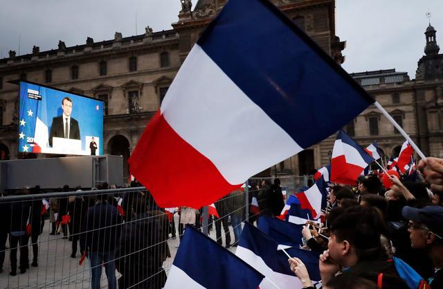 Supporters listen to French president-elect Emmanuel Macron as he delivers a speech at the Pyramid at the Louvre Museum in Paris on May 7, 2017, after the second round of the French presidential election. (AFP) Supporters listen to French president-elect Emmanuel Macron as he delivers a speech at the Pyramid at the Louvre Museum in Paris on May 7, 2017, after the second round of the French presidential election. (AFP)