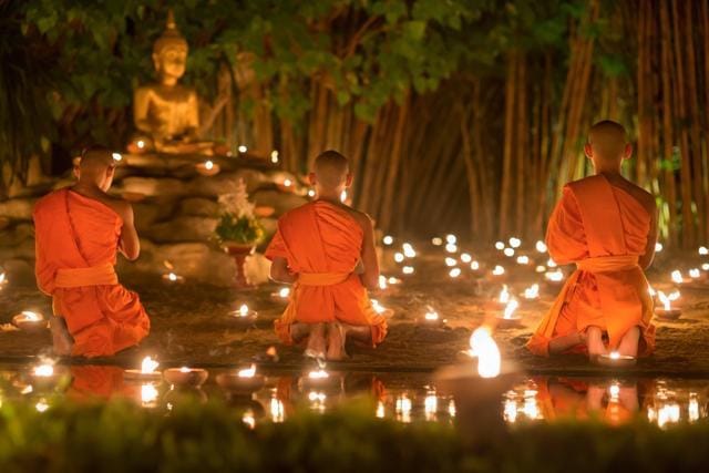 Monks light candles and pray to Buddha statue in Phan Tao temple , Chiang mai ,Thailand. (Shutterstock) Monks light candles and pray to Buddha statue in Phan Tao temple , Chiang mai ,Thailand. (Shutterstock)