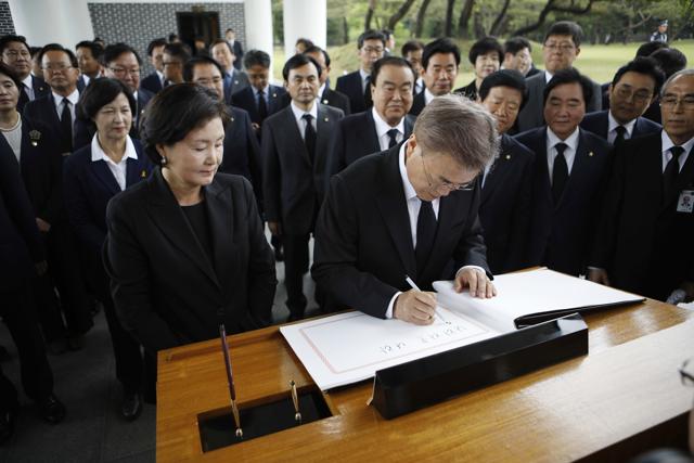 South Korea's President Moon Jae-in writes on a visitor's book at the National Cemetery in Seoul. Moon visited the cemetery where he honoured former presidents, independence fighters and war heroes. (AP)