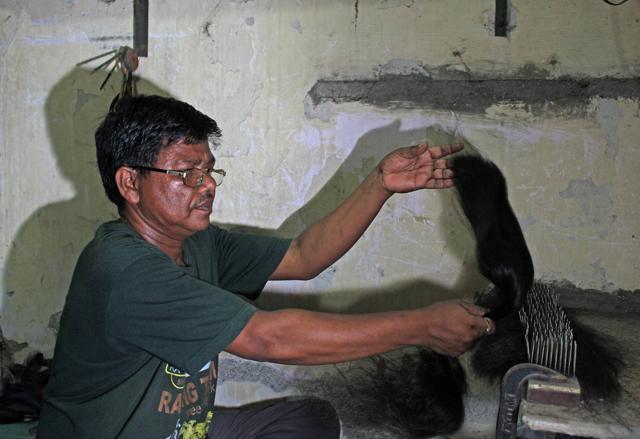Donated hair is sorted carefully into ‘plaits’ based on length, colour and texture. Each plait is then brushed carefully to remove all knots. It is now ready to be rooted into a ‘cap’. (Satyabrata Tripathy / HT Photo)